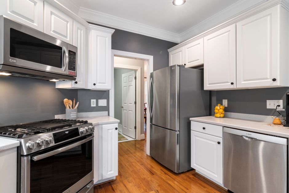 Contemporary kitchen with stainless steel appliances and white cabinets