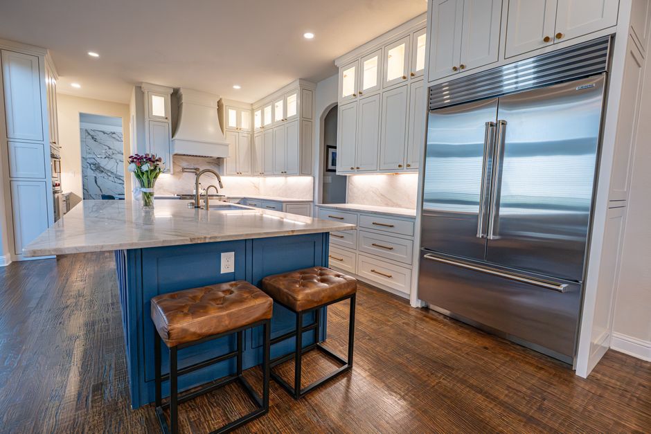 Spacious kitchen featuring marble countertops, a center island, stainless steel appliances